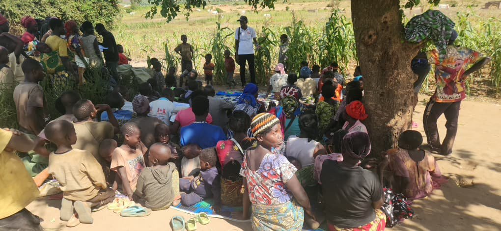 Women and children gathered for a community outreach session