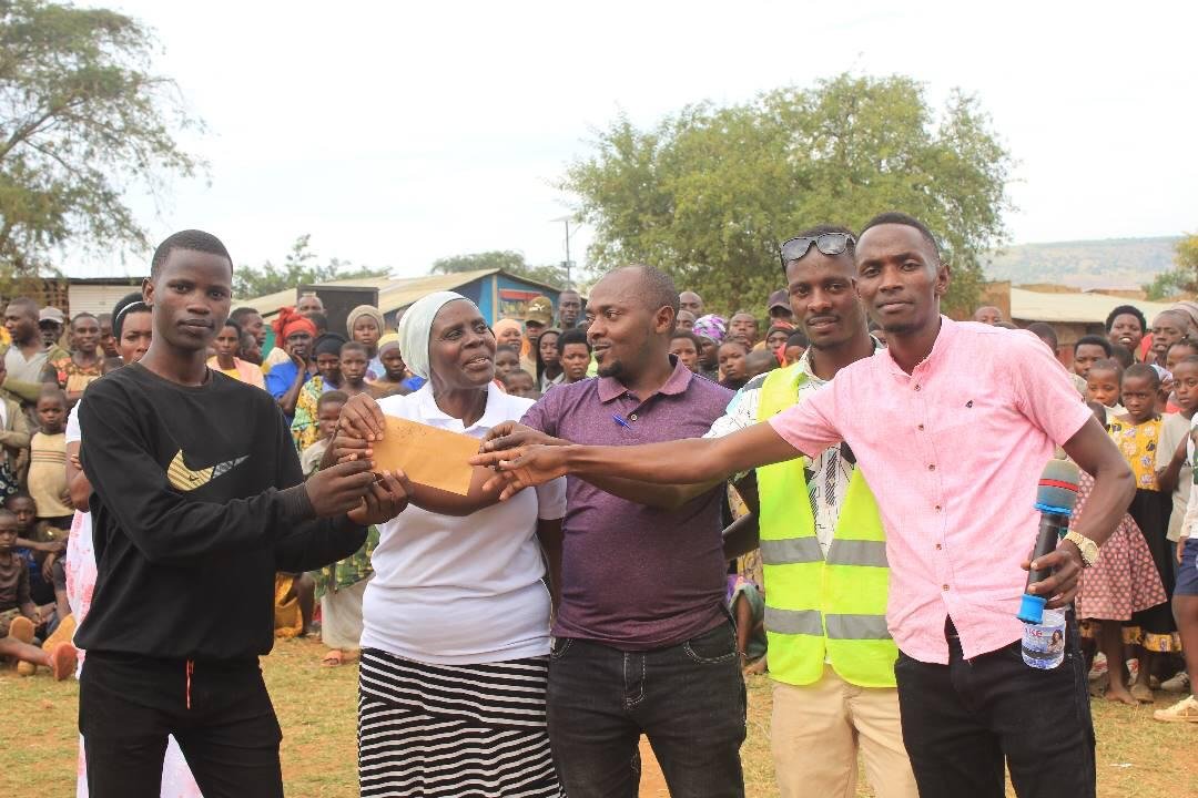 DigniRise staff handing over support materials to a beneficiary
