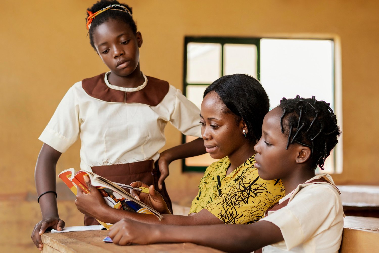 DigniRise staff supporting a young girl with school materials